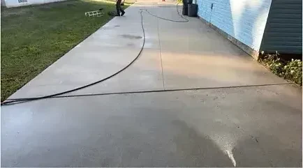 The same driveway after surface cleaning, back to an even light gray