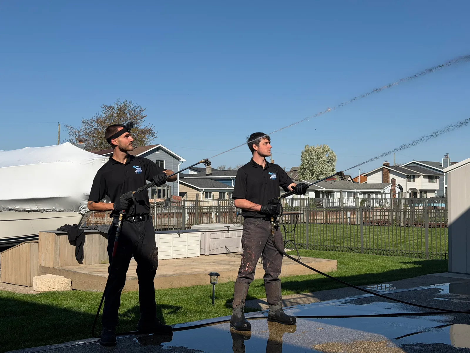 Two MPWS technicians working together on a residential driveway